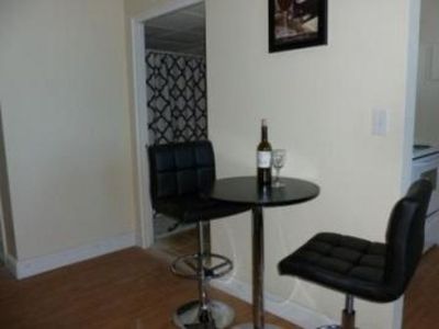 A small table with a bottle of wine and two glasses on it