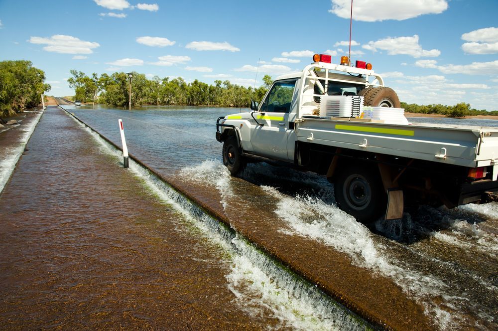 White Truck Driving Through Floodwater on a Road, Outdoors on a Sunny Day — GC Custom Fabrication in Tweed Heads, NSW