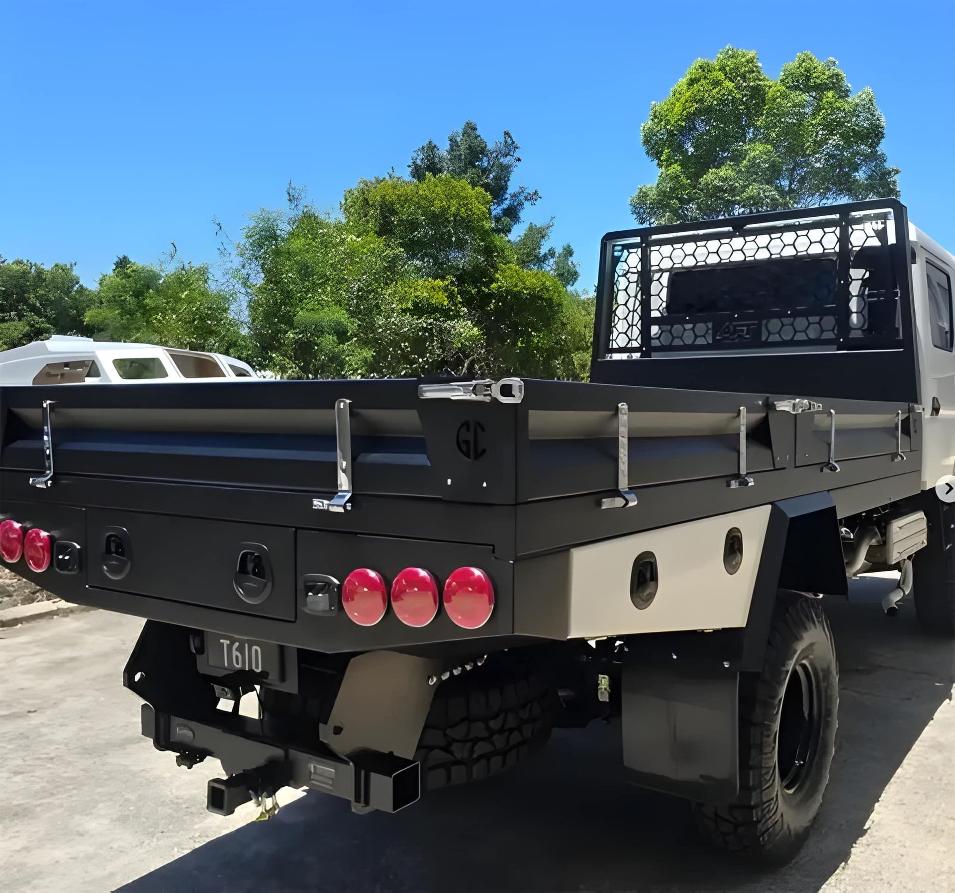 Flatbed Truck With Black Tray and Beige Cab, Parked Outside on a Sunny Day — GC Custom Fabrication in Molendinar, QLD