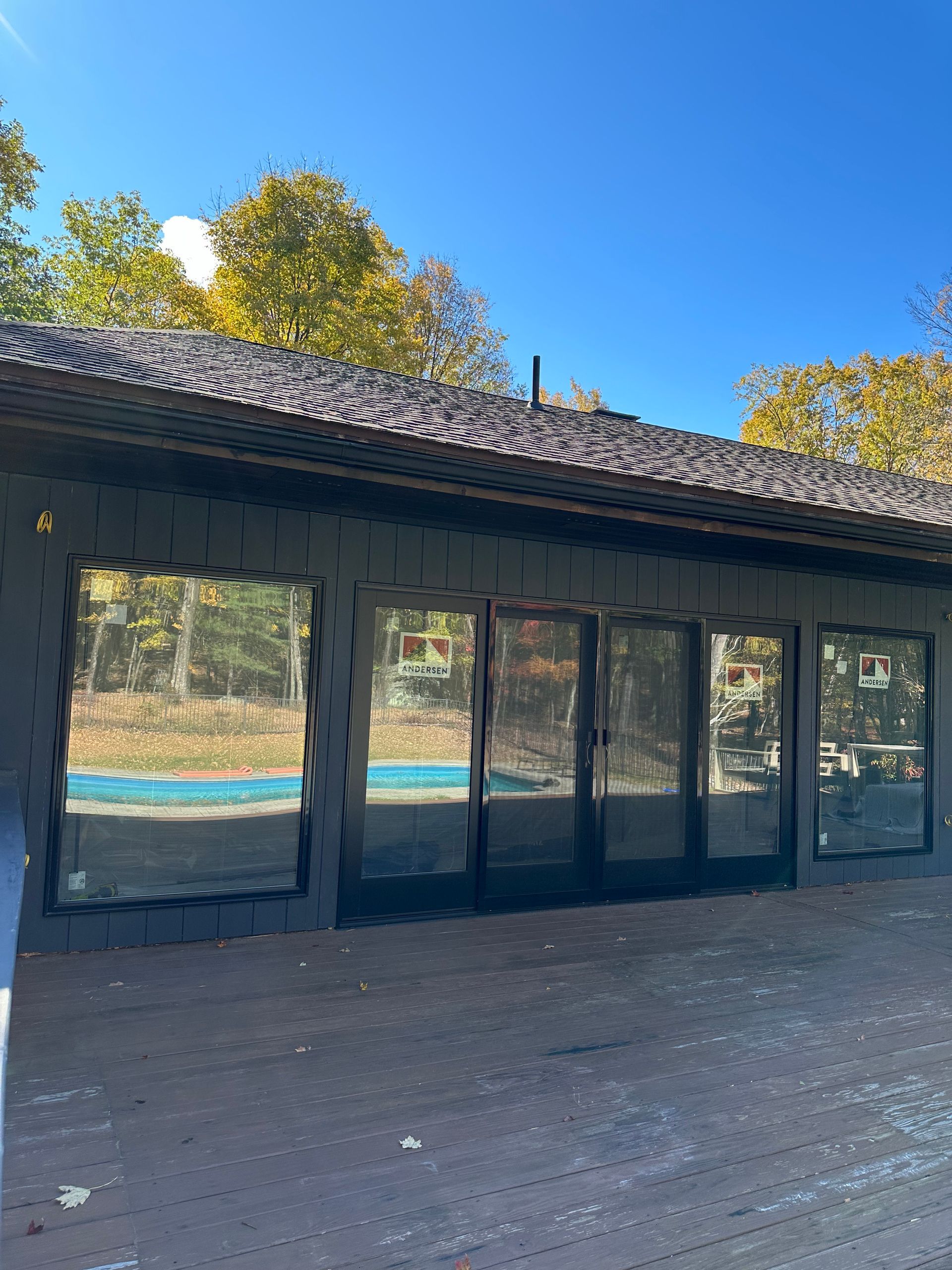 A building with a lot of windows and a pool in the background.