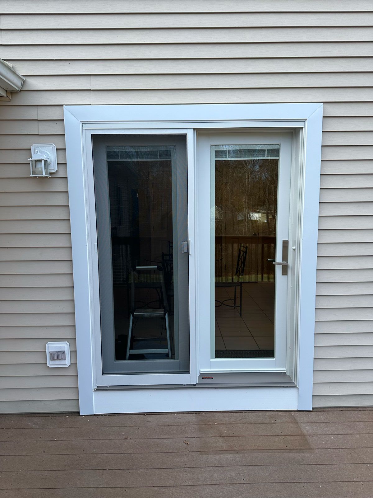 A sliding glass door with a ladder in front of it