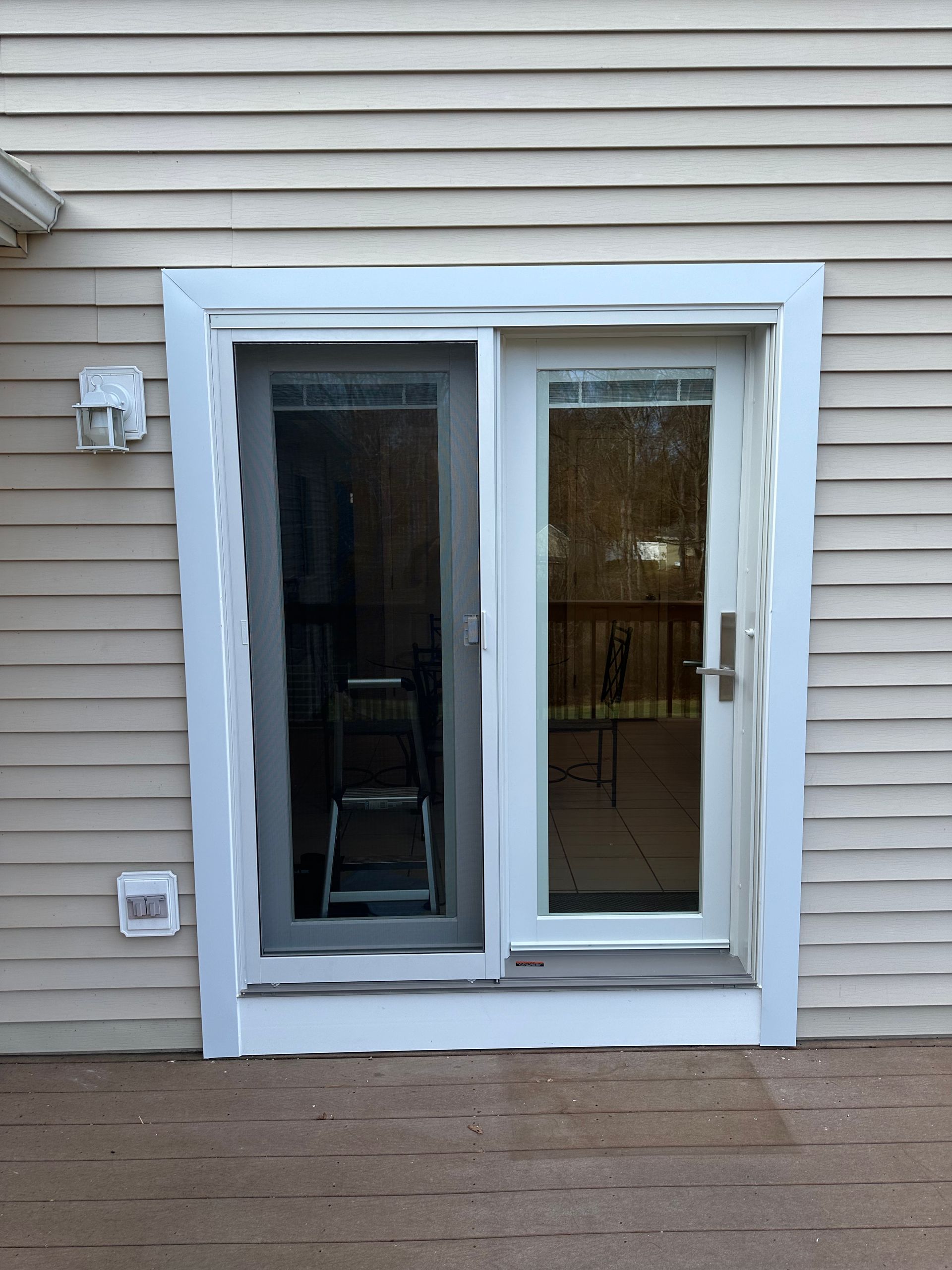 A sliding glass door with a ladder in front of it