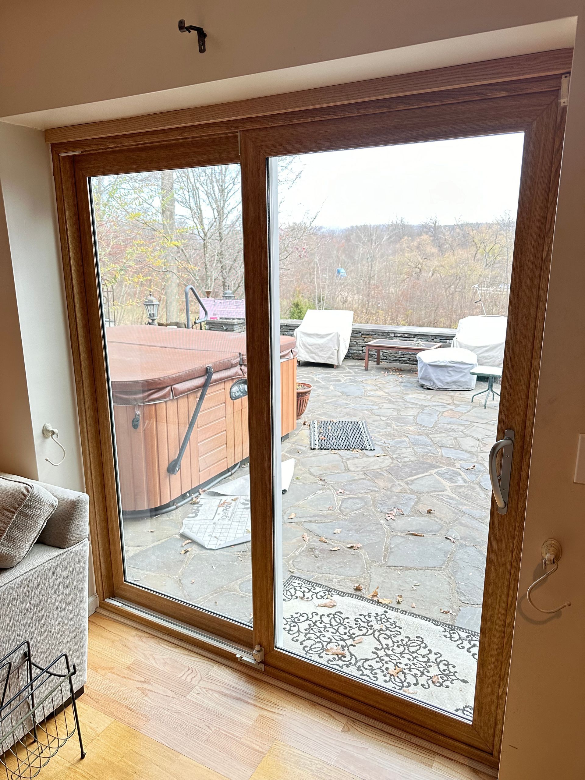 A living room with a sliding glass door leading to a hot tub.