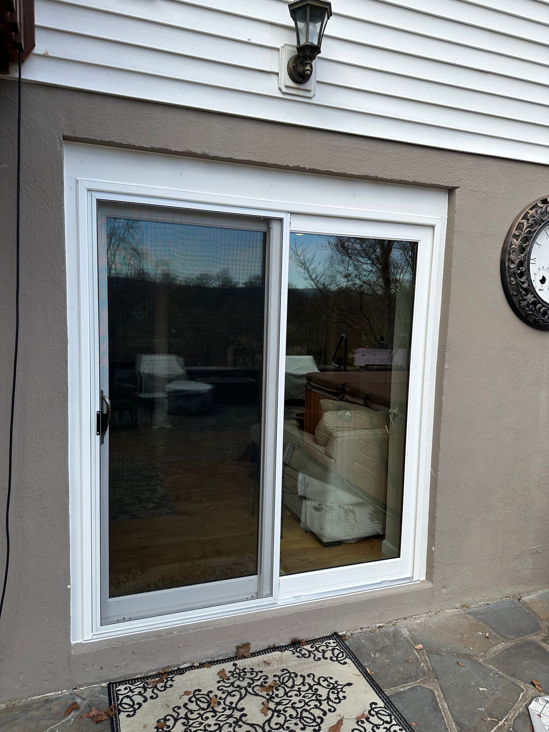 A sliding glass door is open to a living room.