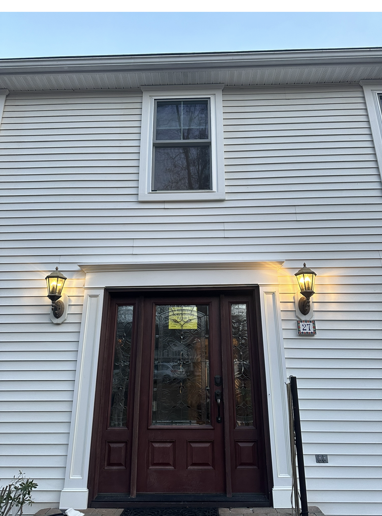 A white house with a brown door and a window