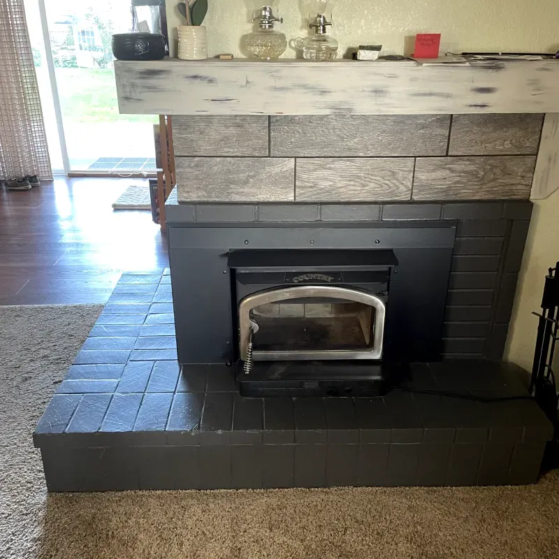 A fireplace with a wood stove built into it