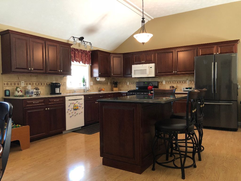 A kitchen with a large island and stainless steel appliances
