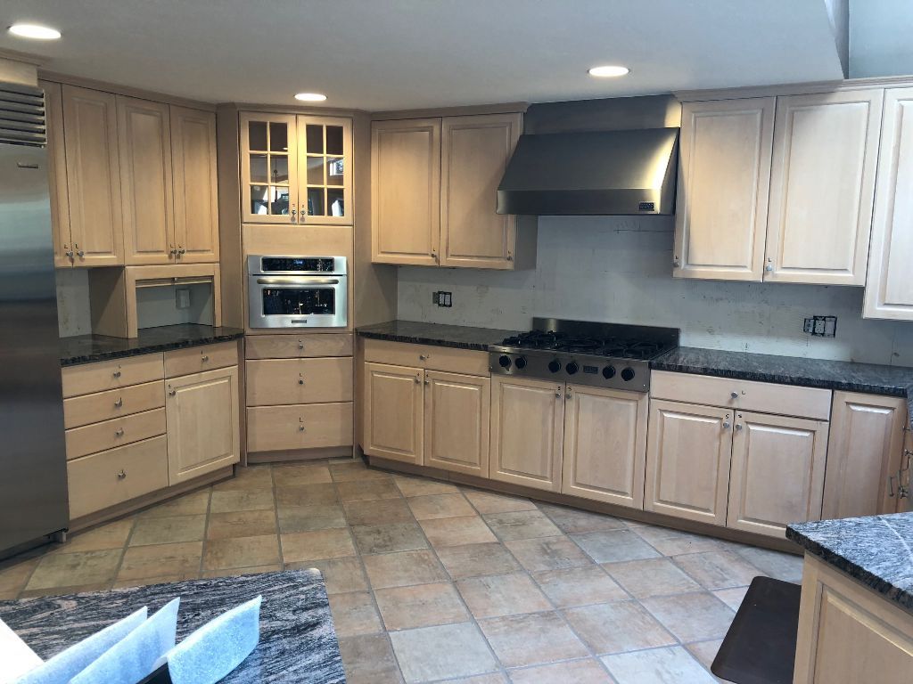 A kitchen with stainless steel appliances and wooden cabinets