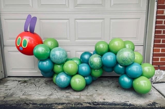 A caterpillar made out of green and blue balloons.