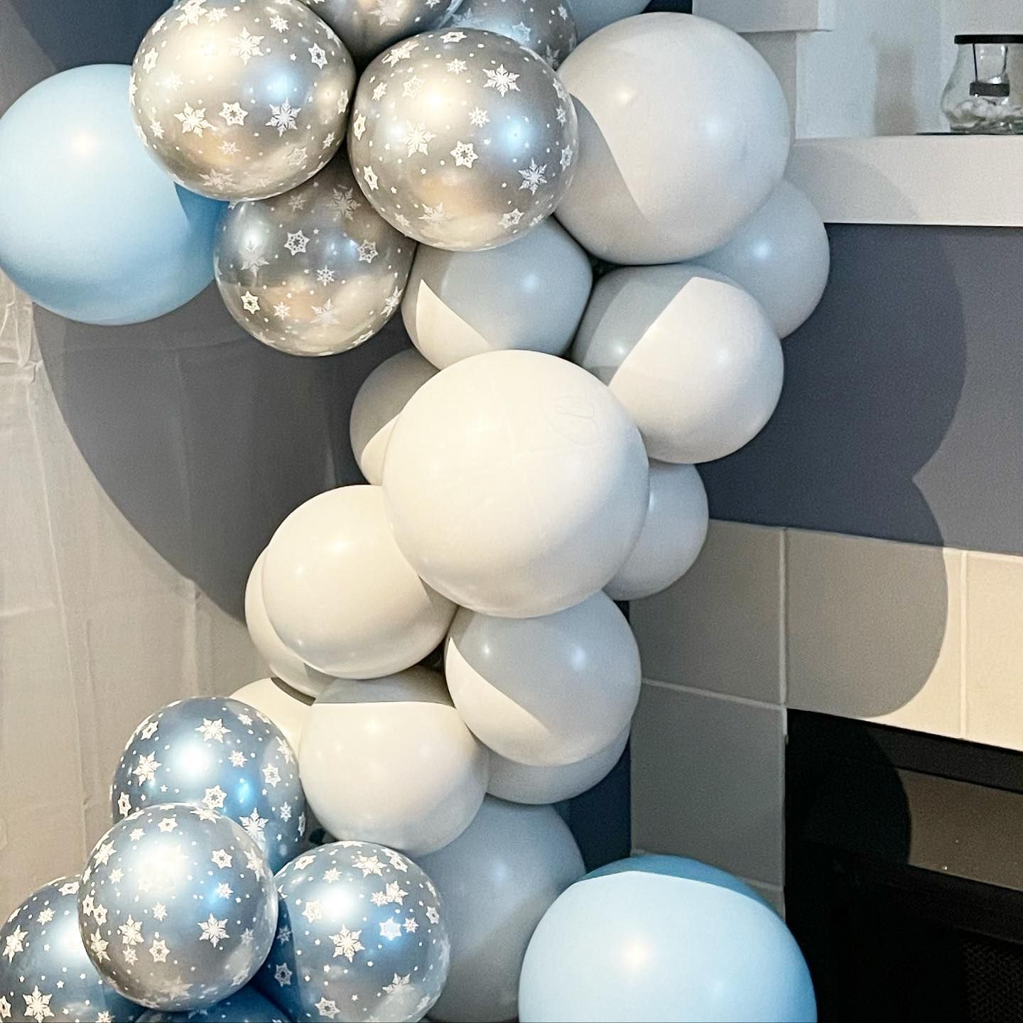 A bunch of blue and white balloons with stars on them.