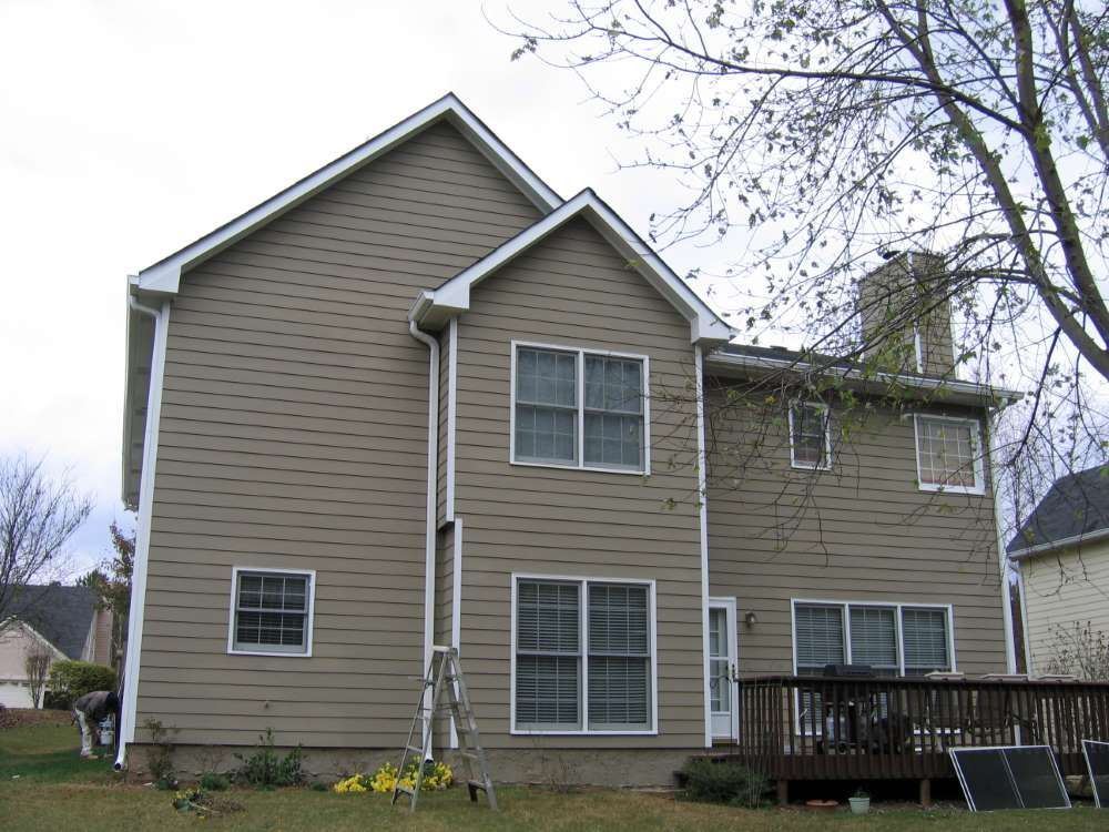 A large house with a lot of windows and a deck