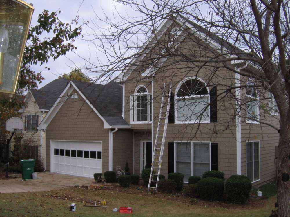 A large house with a ladder in front of it