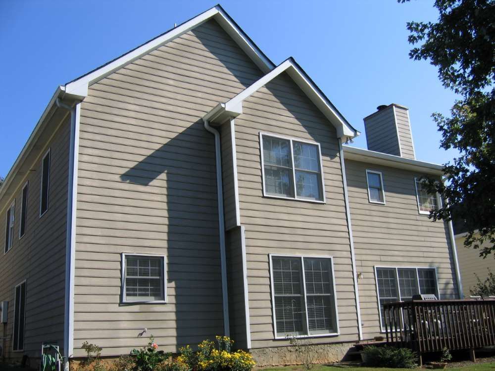 A large house with a lot of windows and a deck