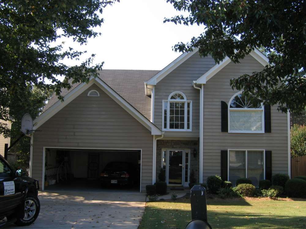 A large house with a car parked in front of it