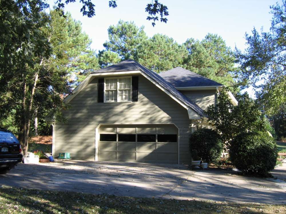 A house with a black car parked in front of it