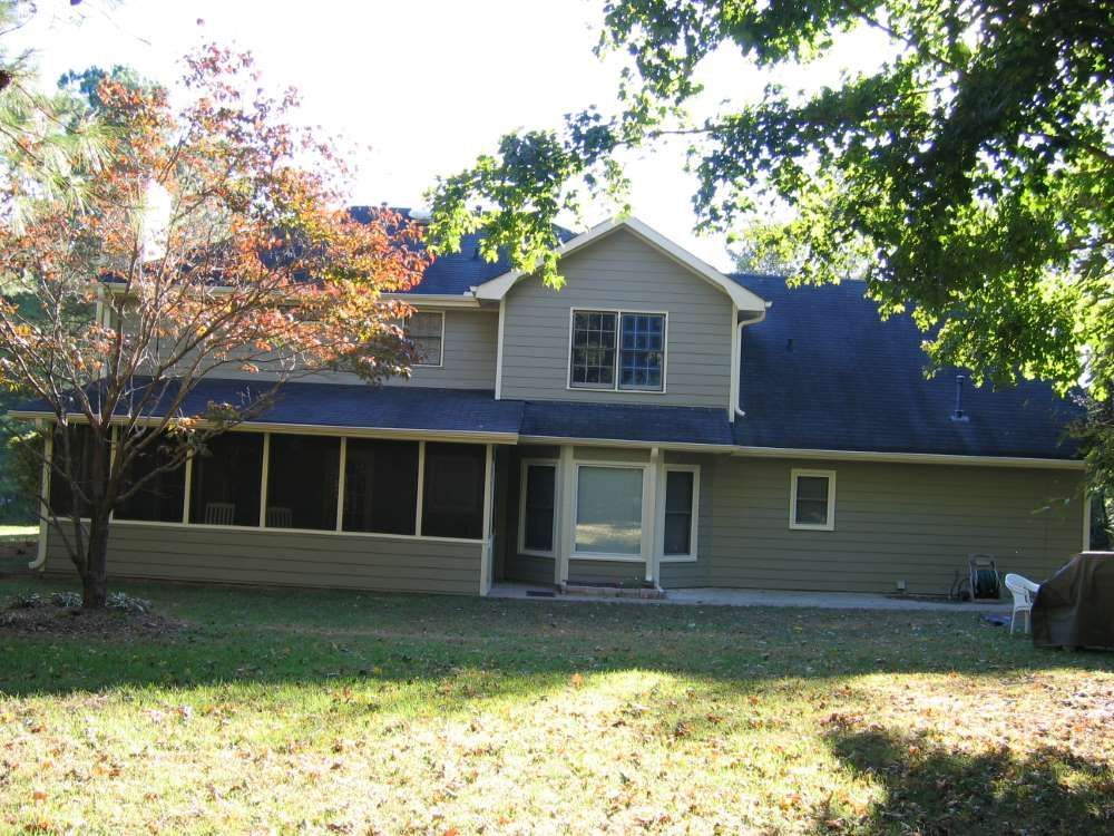 A house with a screened in porch and a blue roof