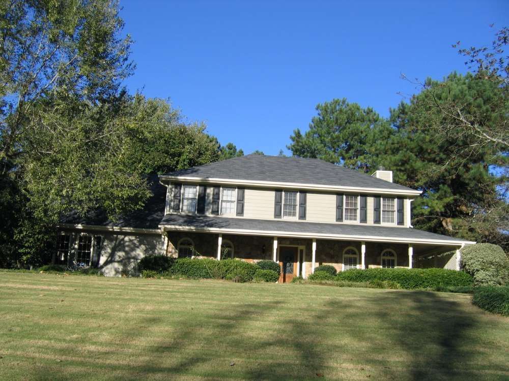 A large house with a large lawn in front of it