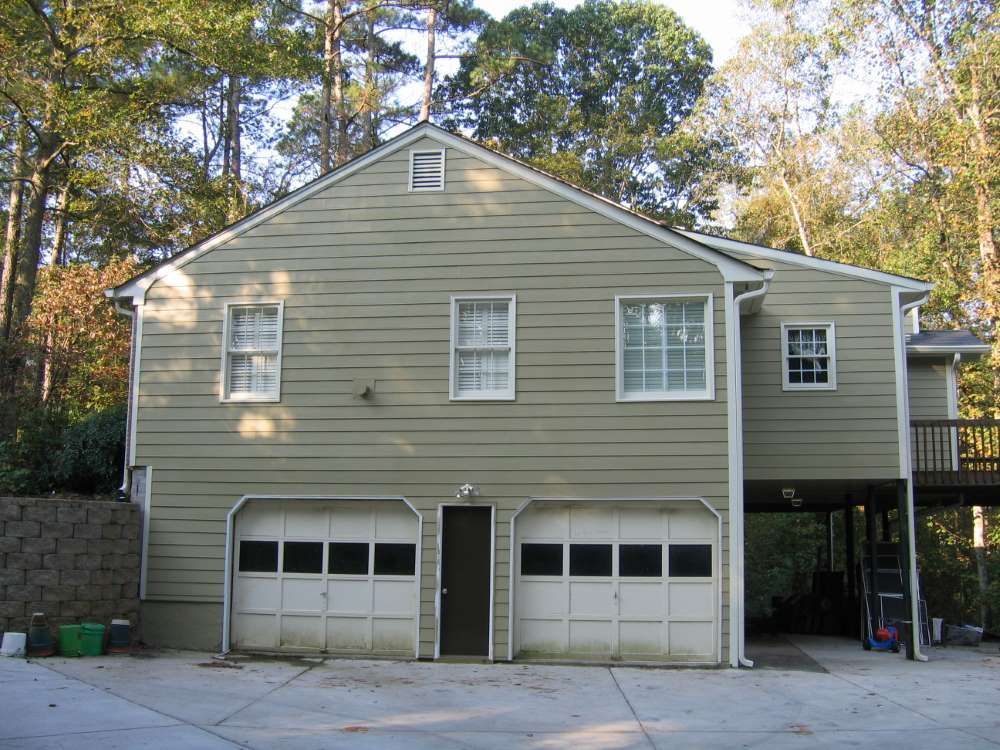 A large house with two garage doors and a deck
