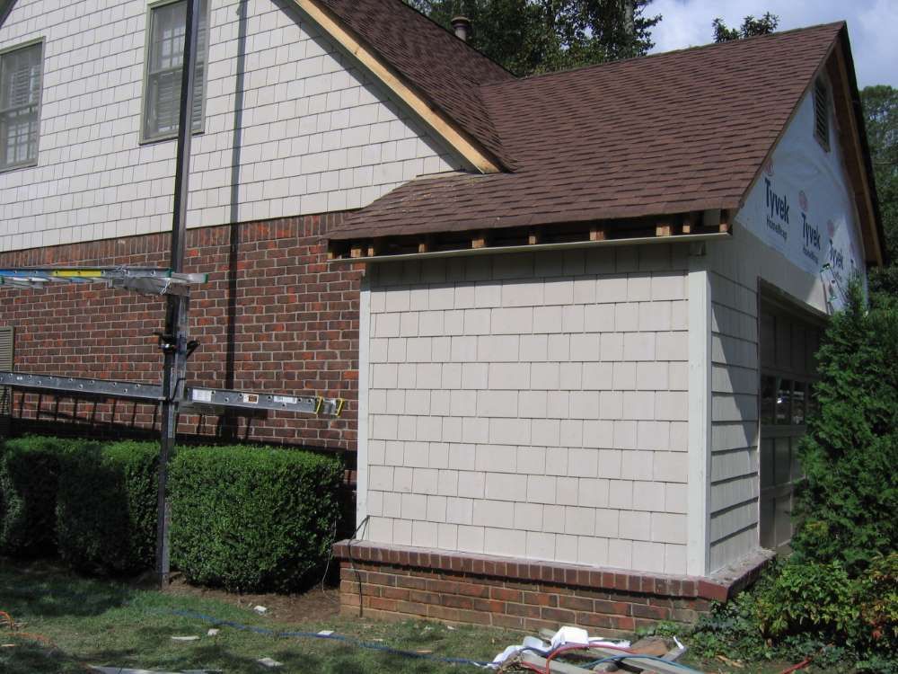 A shed is being built on the side of a house