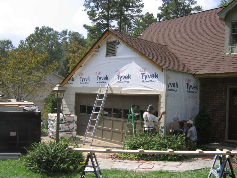 A house with a ladder in front of garage door