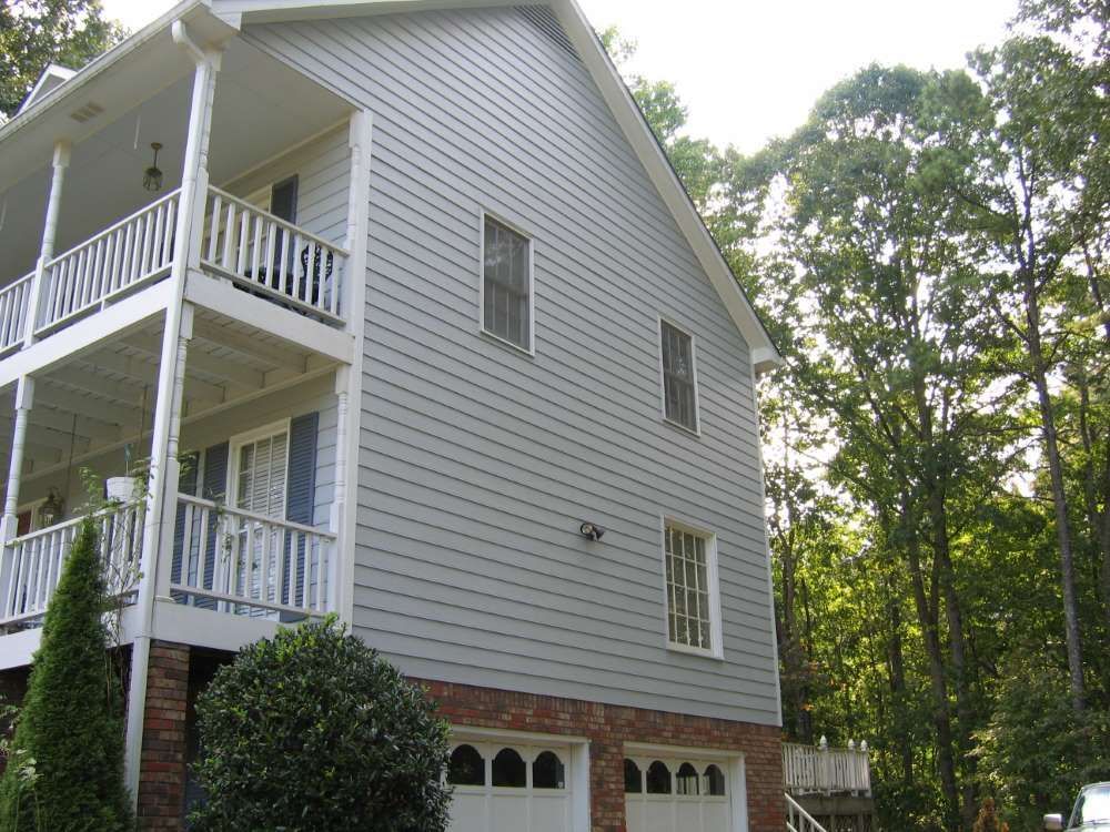 A large white house with a balcony and a garage