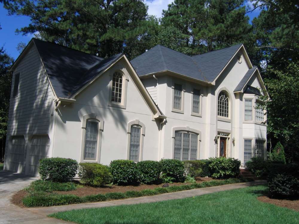 A large white house with a black roof