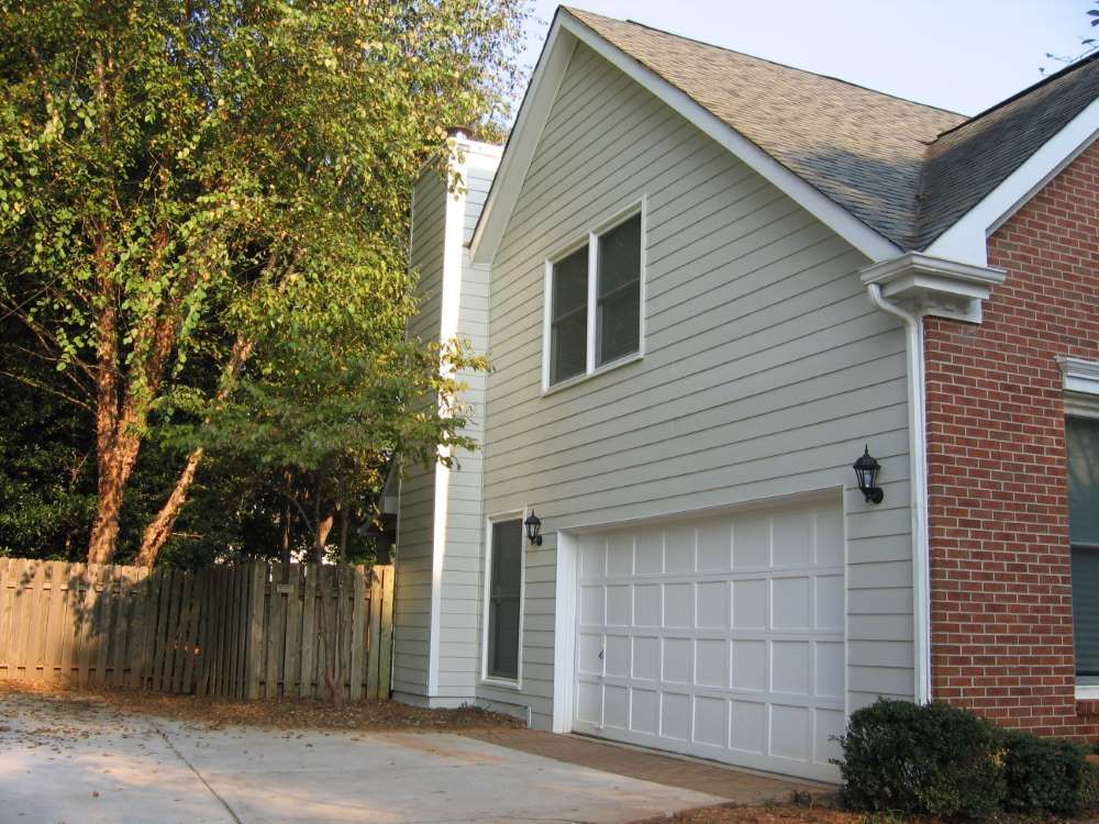 A brick house with a white garage door