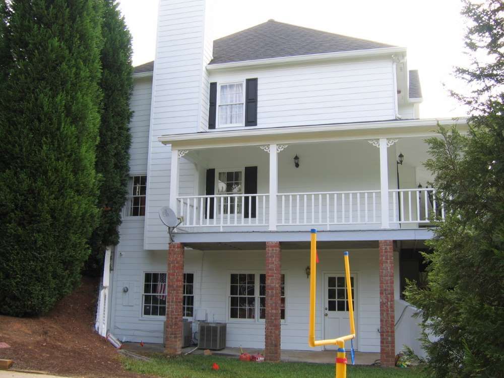A large white house with a large porch