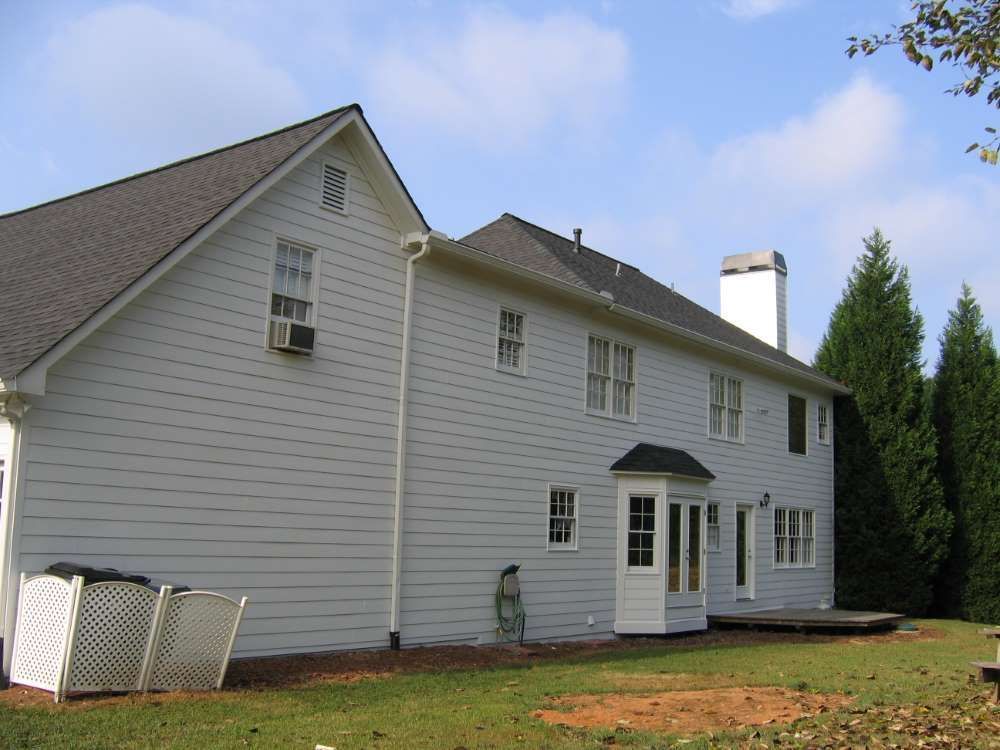 A large white house with a gray roof