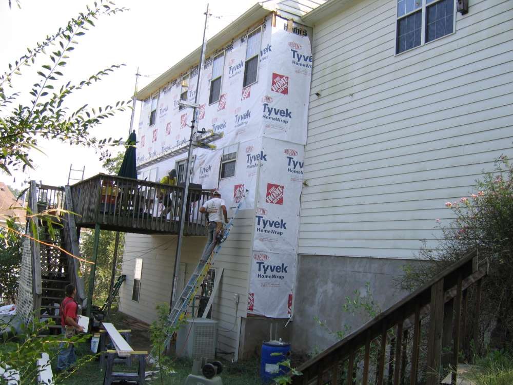 A tyvek siding is being installed on the side of a house