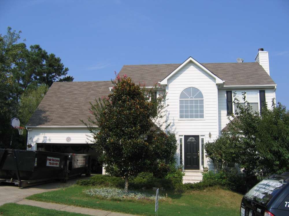 A large white house with a brown roof