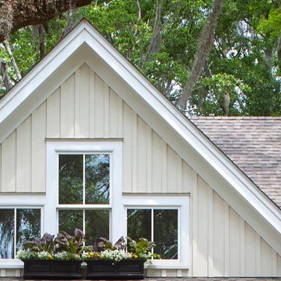 A white house with a vaulted roof and two windows