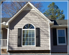 A house with a large window and black shutters