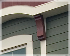 A green house with a white trim and a window