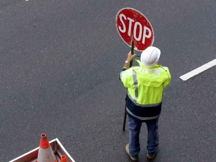 A traffic controller stopping traffic