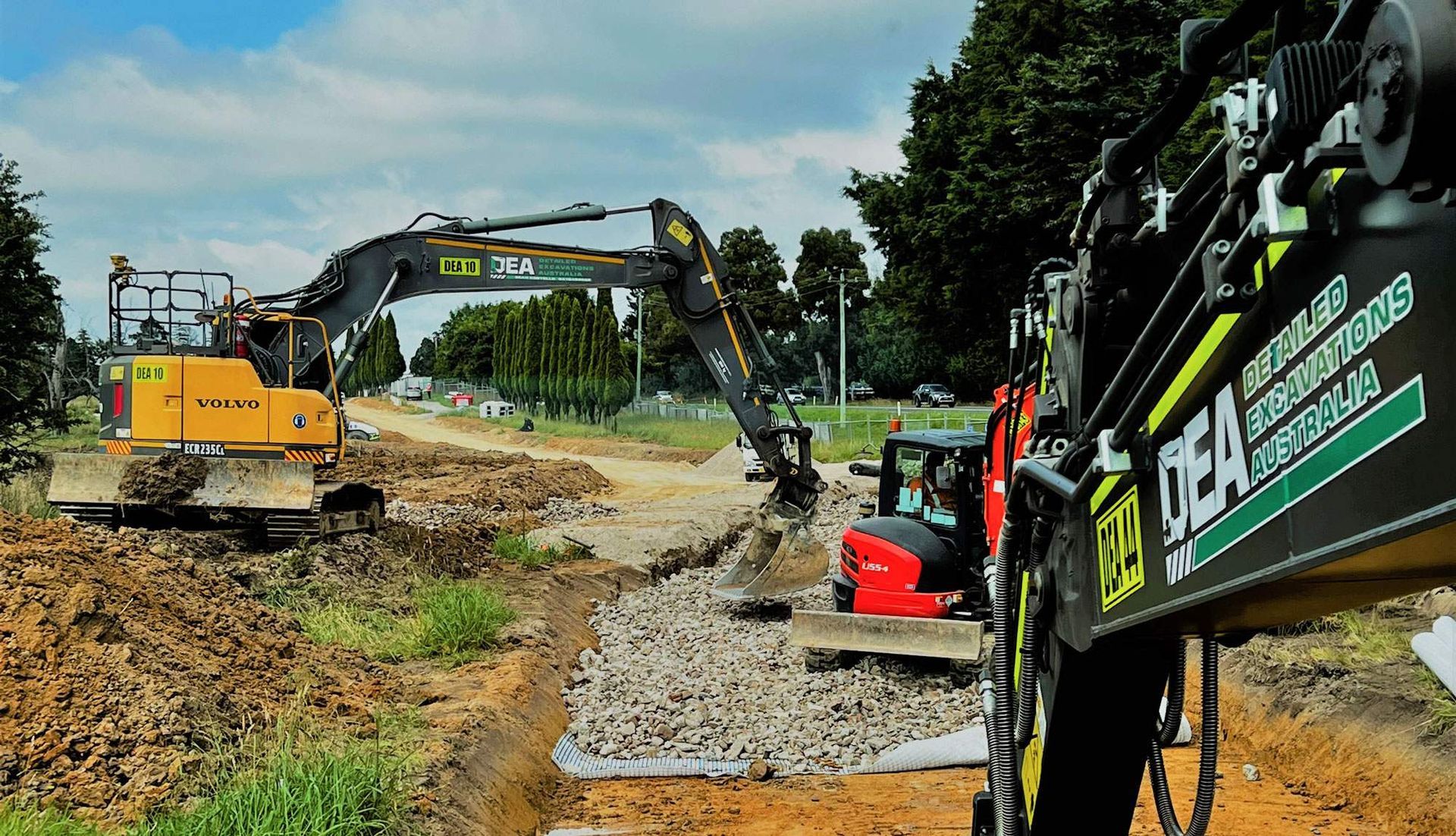 3 Excavators clearing a road