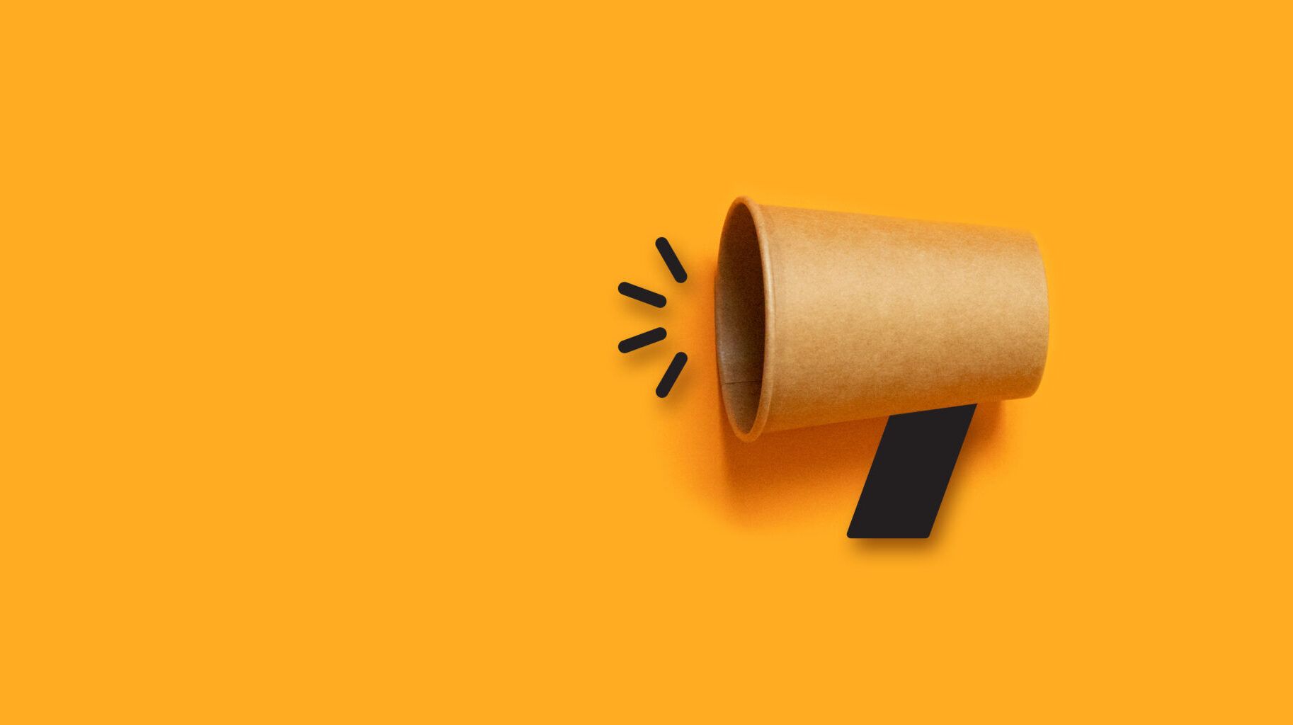 Brown paper megaphone icon on orange background.