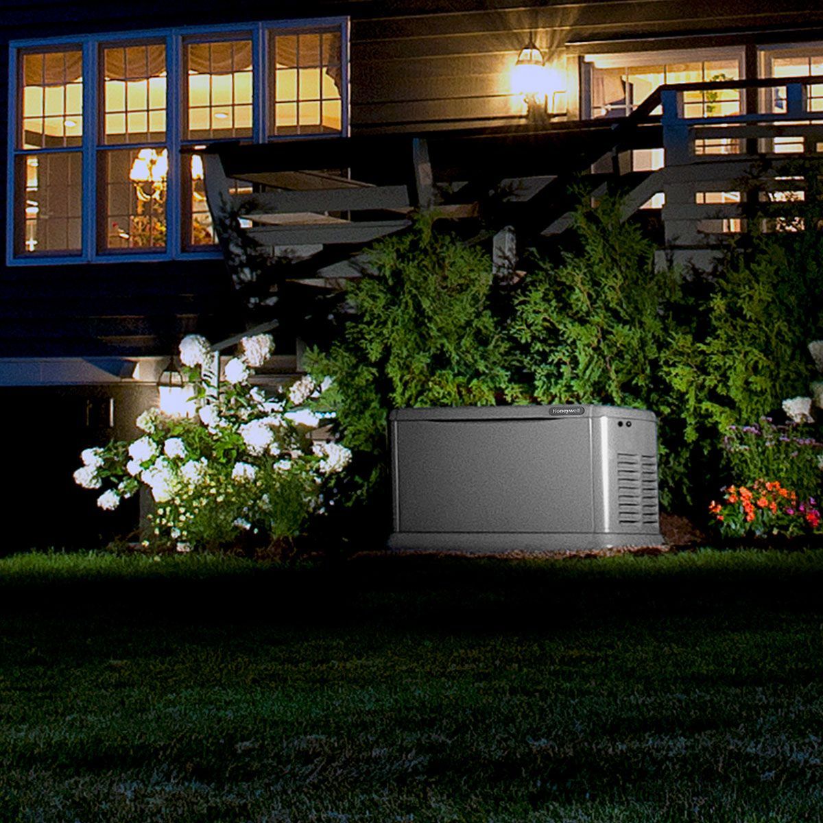A house with a generator in front of it at night
