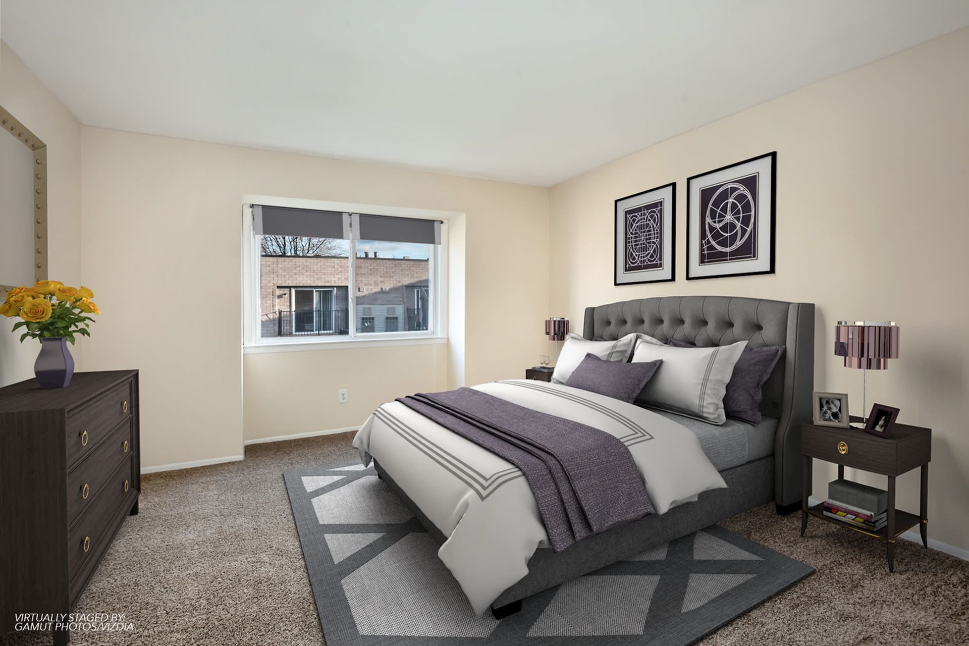 Bedroom with a gray upholstered bed, dresser, two nightstands, and geometric wall art by a window.