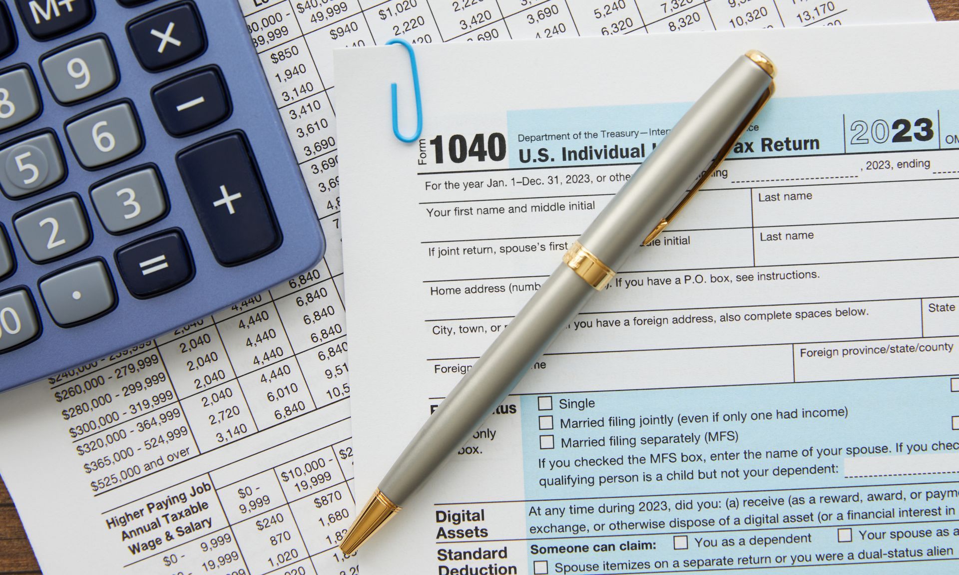 Tax form with a calculator, Income Tax Preparation Concept