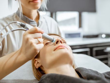 A woman is getting a facial treatment at a beauty salon.