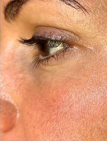 A close up of a woman 's eye with makeup on.