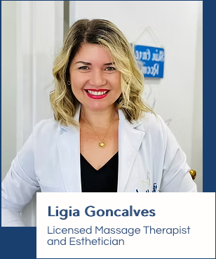 A woman in a white coat is standing in front of a door.