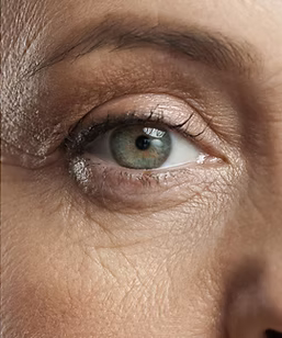 A close up of an older woman 's green eye