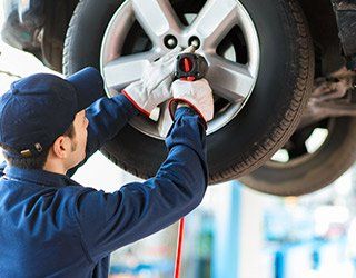Mechanic Fixing Tire - Auto Service in Tampa, FL
