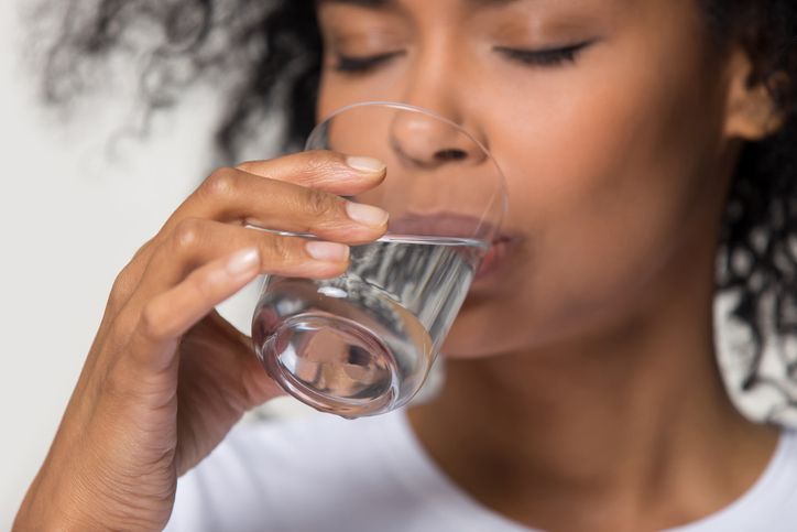 Woman Drinking Glass of Clear Water