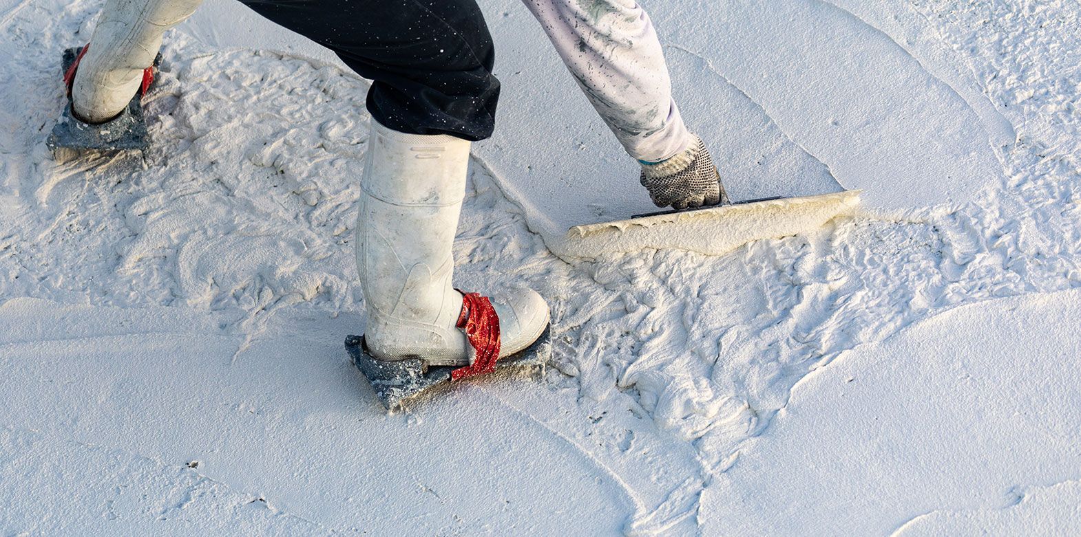 A person wearing snowshoes is walking in the snow.