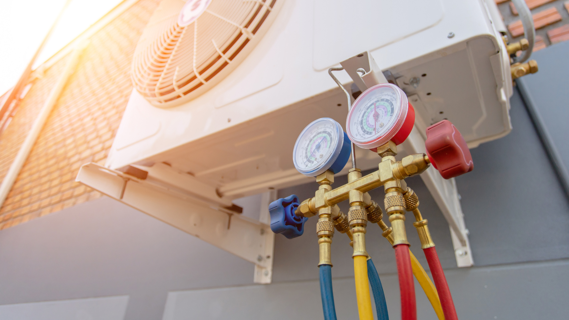 A close up of a air conditioner with gauges attached to it.