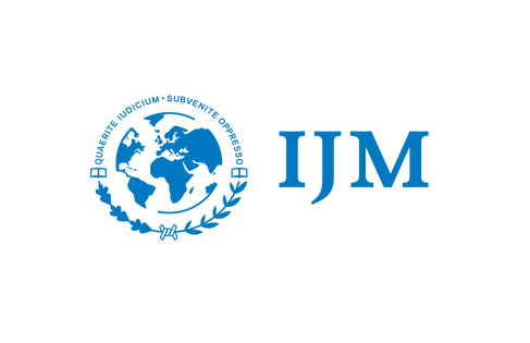 A logo for ijm with a globe and laurel wreath