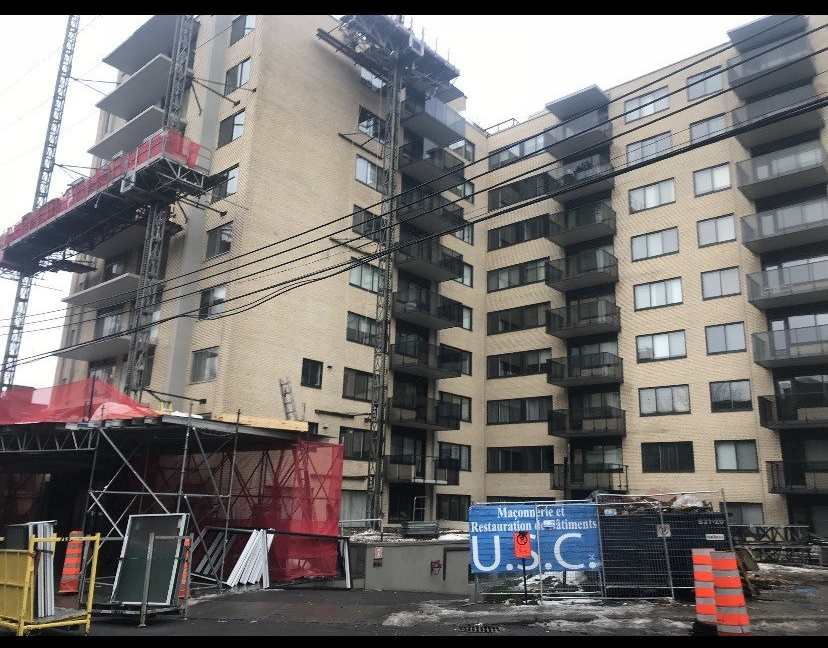 A large building under construction with a u.s.c. sign in front of it
